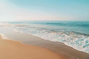 Empty Golden Sand Beach with Gentle Waves and Clear Blue Sky   nature background photo
