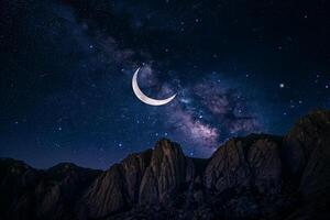 Crescent Moon with Starry Sky Over Mountain Range photo
