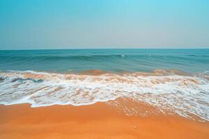 Empty Stretch of Golden Sand with Gentle Waves Lapping at the Shore Under a Clear Blue Sky Background Nature photo