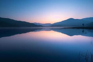Sunrise Over a Tranquil Mountain Lake with Nature Background and Reflective Water photo