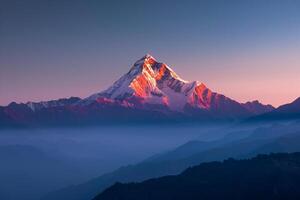 Snow Capped Mountain Peak Glowing in the First Light of Dawn Background photo