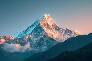 Snow Capped Mountain Peak Glowing in the First Light of Dawn Background photo