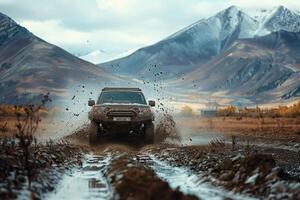 Off road SUV crossing a muddy terrain. splashing mud. with mountains in the background photo
