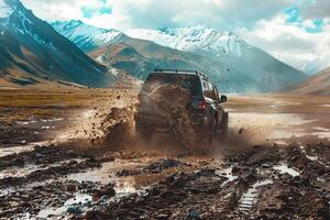 Off road SUV crossing a muddy terrain. splashing mud. with mountains in the background photo