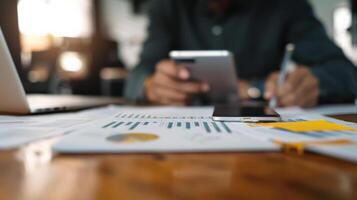 Professional analyzing financial documents with a tablet and charts. Concept of business strategy, planning and finance. photo
