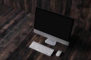 Computer monitor mockup with blank screen on a  walnut wood background photo