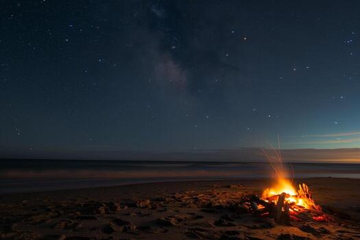 sereno playa hoguera debajo estrellado noche con Oceano brisa antecedentes foto