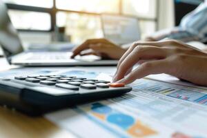 Hands at Desk Using Calculator for Tax Returns Background photo