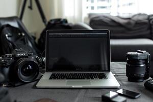 Laptop Mockup Background for Editing s Surrounded by Camera Gear photo