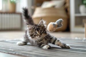 Maine Coon Kitten Enthusiastically Batting at a Toy Mouse with Fluffy Tail Raised in a Fun and Playful photo