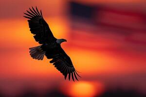 Silhouette of American Bald Eagle Flying Against Sunset Sky with American Flag Background photo