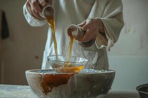 Artisan Pouring Molten Glass into Water Filled M Capturing the Intricate Glassmaking Process photo