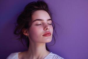 Woman with closed eyes deep in thought against a reflective background photo