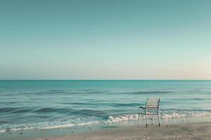 Beach chair alone facing the gentle ocean waves providing a serene and calming seaside perspective background photo