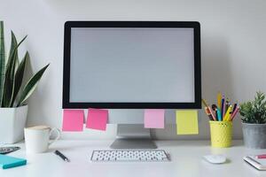 Computer mockup with sticky notes around on a  white desk ideal for showcasing digital projects background photo