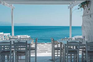 White washed taverna on the beach with a stunning  of the azure sea creating a peaceful seaside atmosphere background photo