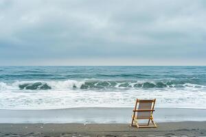 Lone beach chair positioned to face the ocean with gentle waves providing a tranquil and scenicbackground photo