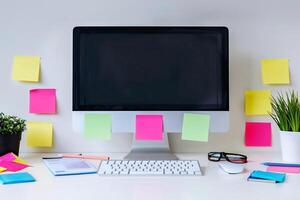 Computer mockup with sticky notes scattered around a white desk perfect for project presentations background photo
