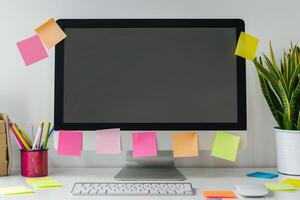 Computer mockup on a white desk surrounded by sticky notes ideal for professional presentations and  projects background photo