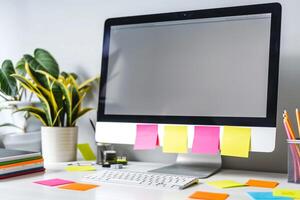 White desk featuring a computer mockup and sticky notes perfect for digital workspace and project management background photo