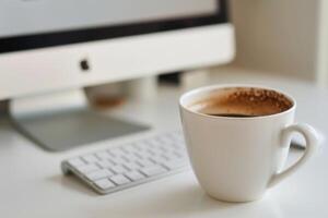 White desk with computer mockup sticky notes and coffee cup ideal for showcasing a stylish and organized office setup background photo