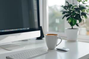 Computer mockup with coffee cup and sticky notes on a white desk providing a stylish and efficient workspace background photo
