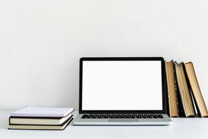 Laptop Mockup with Coding Books on Desk    and Effective Workspace Background photo