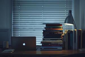 Programmers Desk with Laptop and Coding Books    and Efficient Background photo