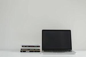 Laptop Mockup with Coding Books for Tech Enthusiasts Background photo