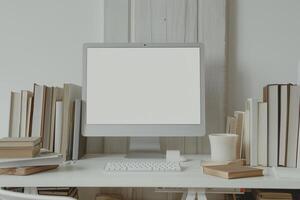 Computer Mockup Background on a White Desk with Books photo