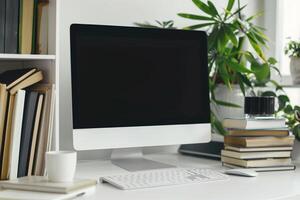 Computer Mockup Background on a White Desk with Books photo