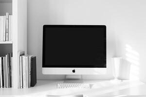 Desk with Computer Mockup and Stacked Books Concentrated Study Environment Background photo
