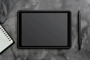 Tablet on Desk with Pen and Notepad in  Office photo