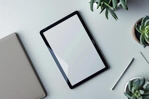 Tablet on Desk with Pen and Notepad and Coffee Mug photo
