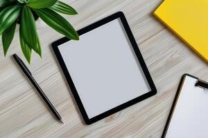 Tablet on Desk with Pen and Notepad in ist Setup photo
