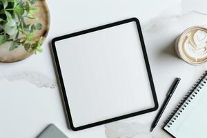 Tablet on Desk with Pen and Notepad and Calendar photo