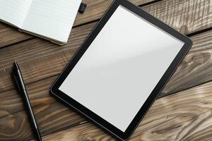 Tablet on Desk with Pen and Notepad and Notebook photo