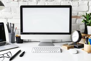 Computer Mockup on White Desk Surrounded by Writing Accessories photo