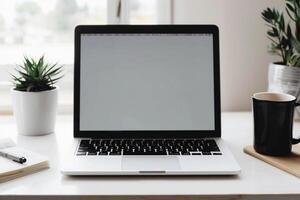 Laptop Mockup with Blank Notebook Open on White Desk photo