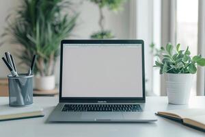 Laptop Mockup with Blank Notebook Open on White Desk photo