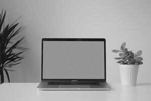 Laptop Mockup with Blank Notebook Open on White Desk photo