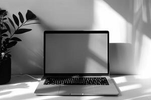 Laptop Mockup with Blank Notebook Open on White Desk photo