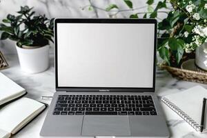 Laptop Mockup with Notebooks Around on White Desk photo
