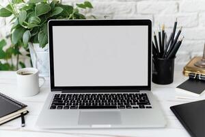 Laptop Mockup with Blank Notebook Open on White Desk photo