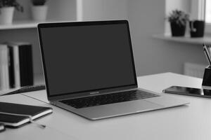 Laptop Mockup with Blank Notebook Open on White Desk photo