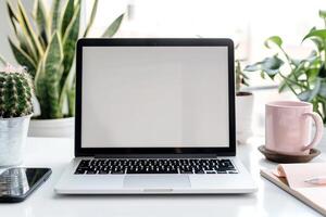 Laptop Mockup with Blank Notebook Open on White Desk photo