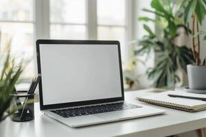 Laptop Mockup with Blank Notebook Open on White Desk photo