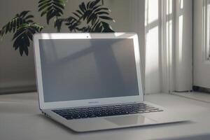Writing and Work Setup with Laptop Mockup on a White Desk and Open Notebook photo