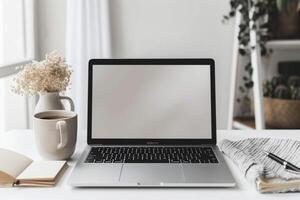 Laptop Mockup with Open Notebook and White Desk for   Work and Writing Background photo