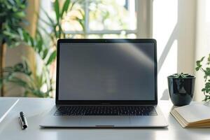 Laptop Mockup with Open Notebook on White Desk for   Work and Writing Setup photo